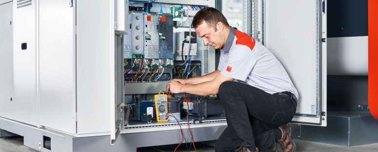 Technician repairing a laser machine